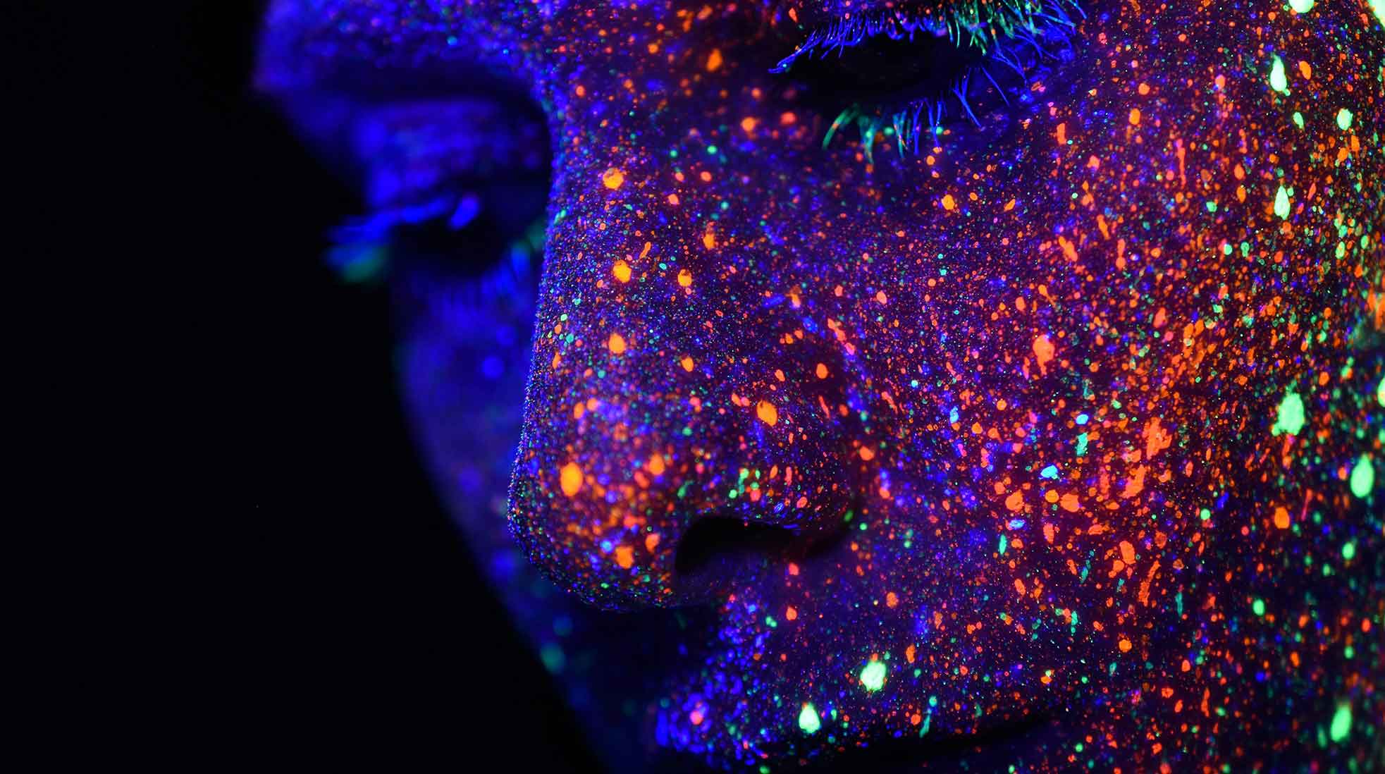 A human face covered with colored dots